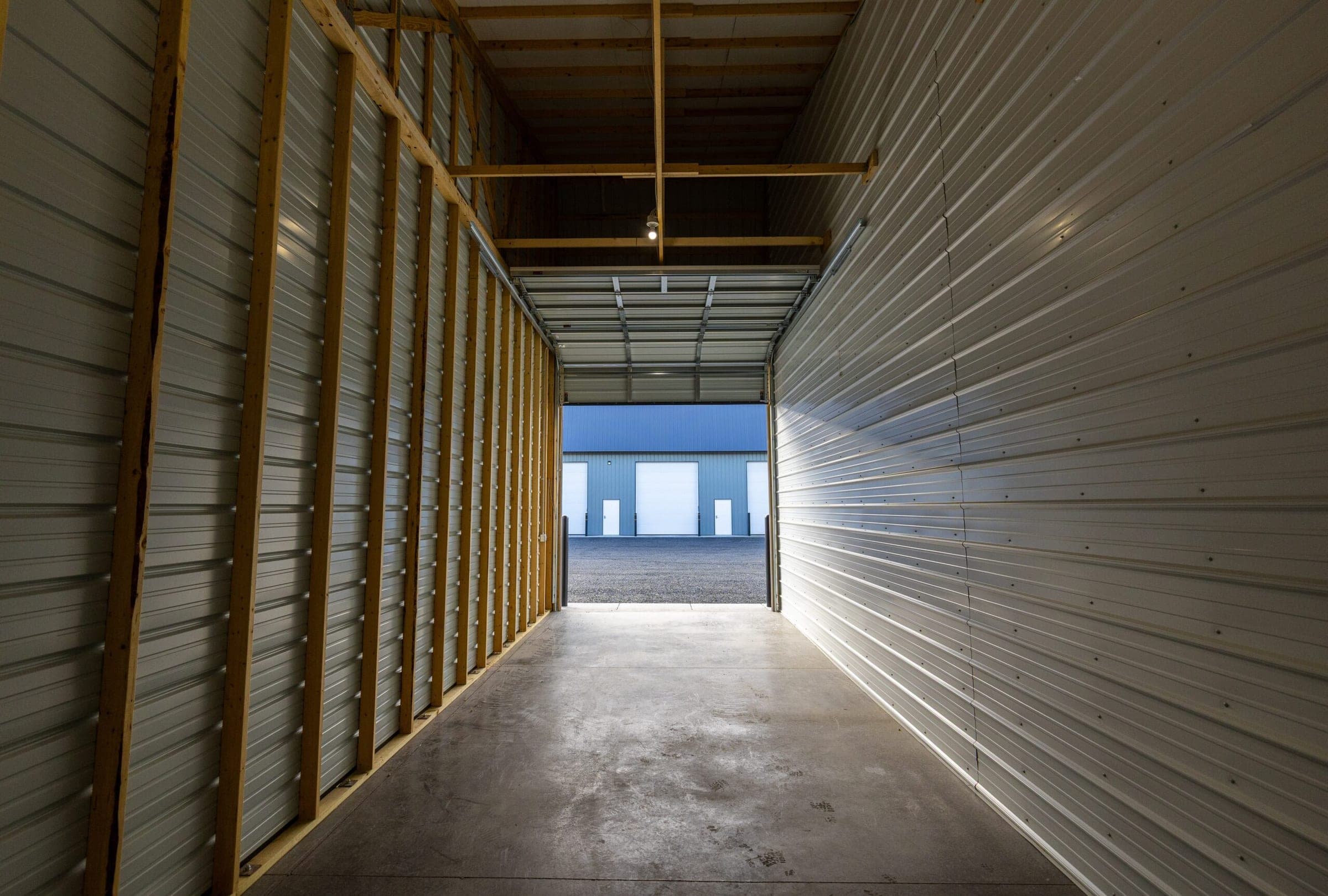 Inside a large Precision One storage unit looking out through the open overhead door