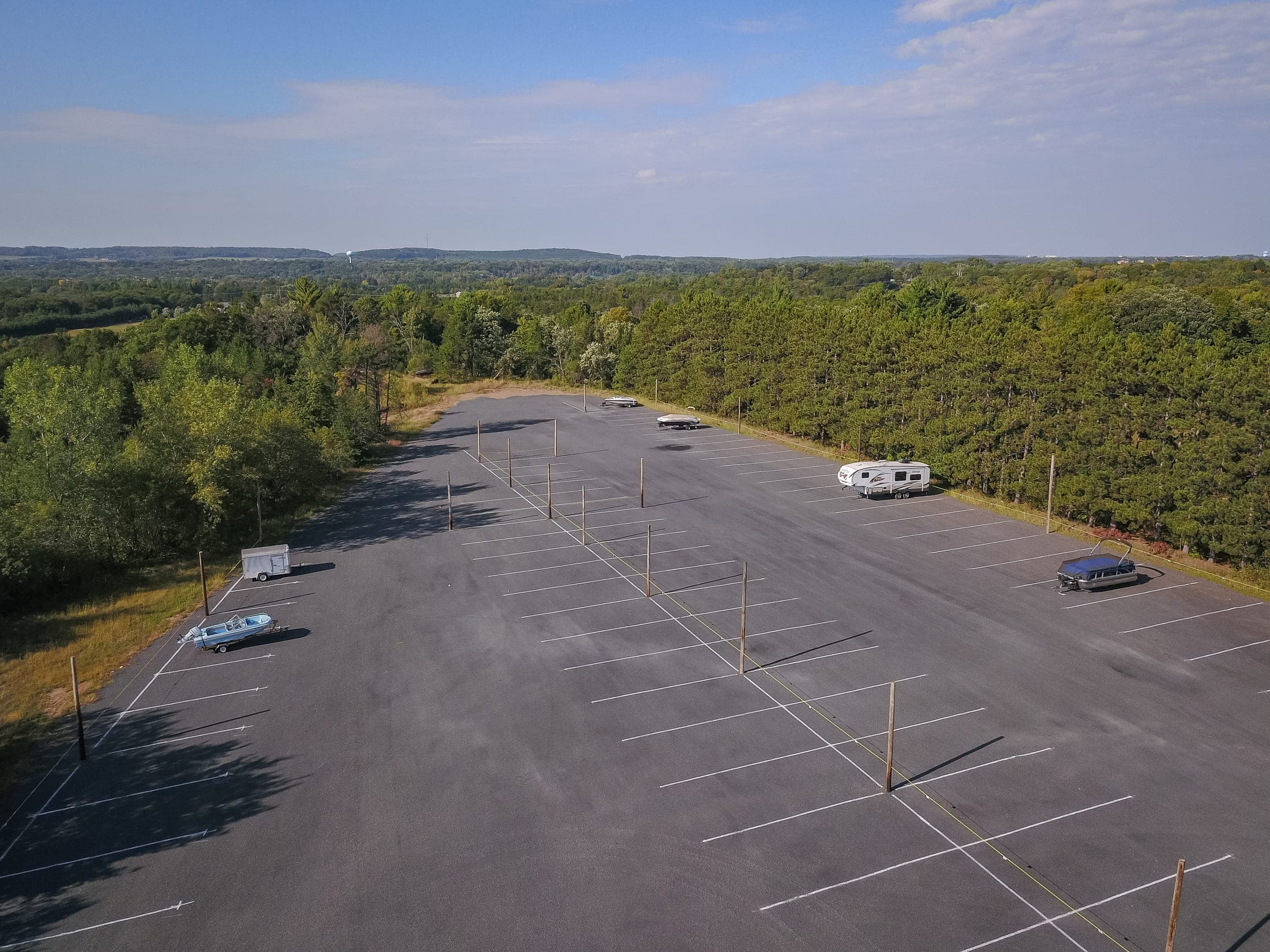 Aerial view of the paved, striped outdoor vehicle storage lot at Precision One Storage