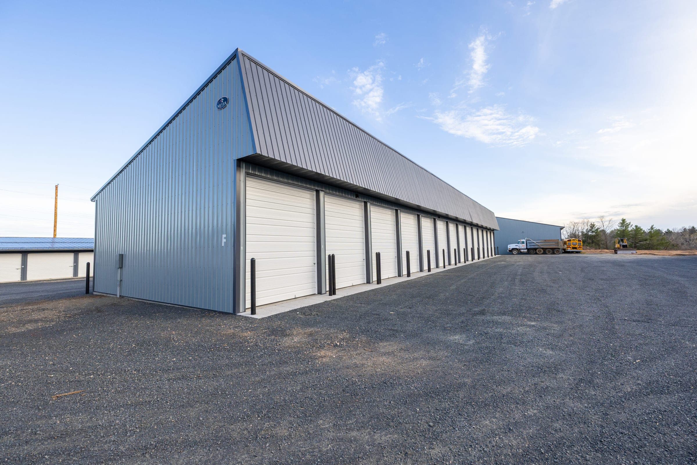 Tall overhead doors along a storage building at Precision One Storage